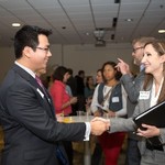 Attendees of the event shake hands